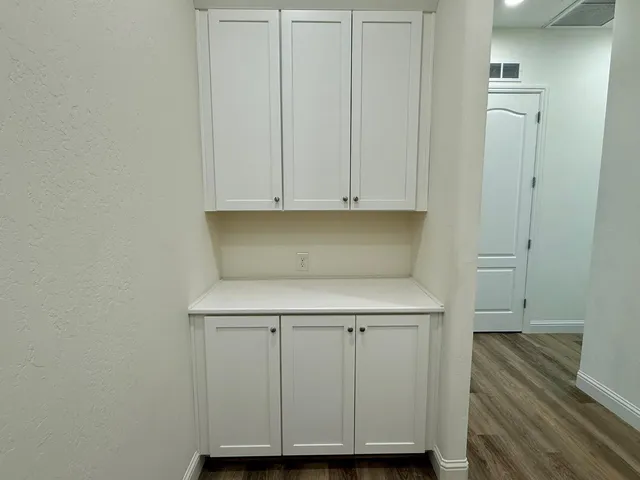 a view of cabinets and wooden floor