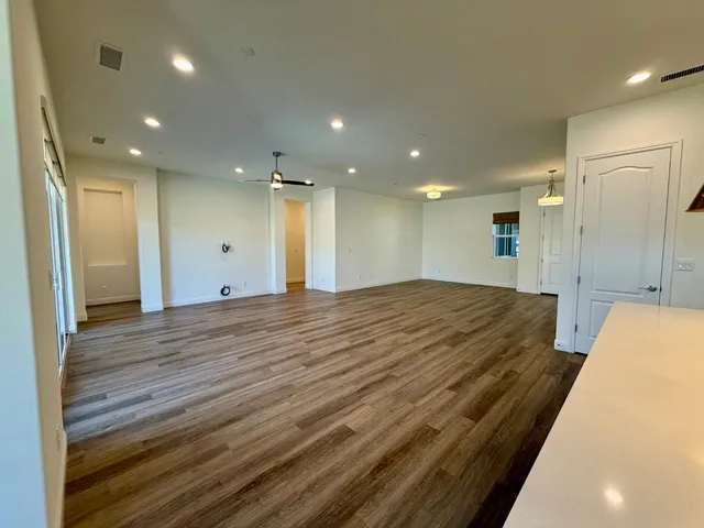 a spacious bathroom with a granite countertop sink and a mirror