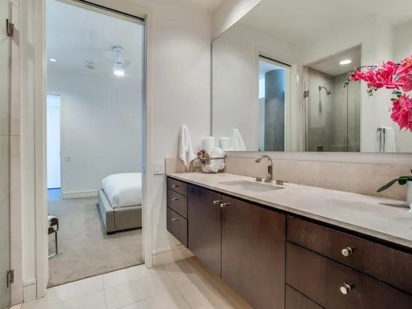a en suite bathroom with a granite countertop sink and a mirror