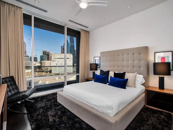 a bedroom with a bed and a lamp