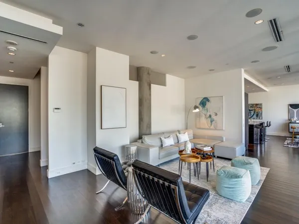 a living room with furniture and wooden floor