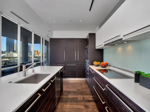 a kitchen with stainless steel appliances a sink and a stove