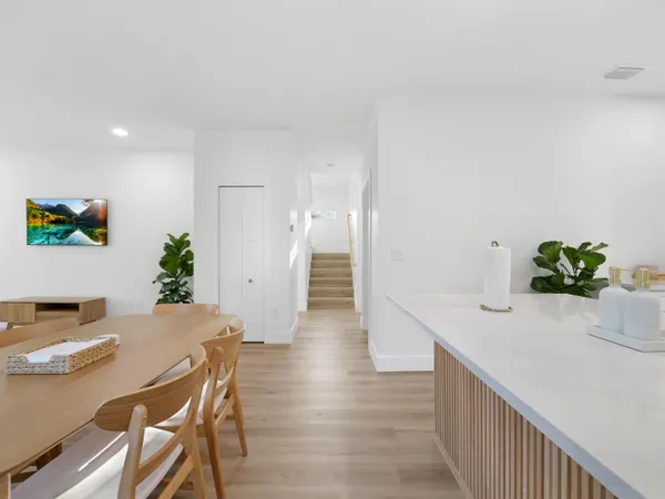a view of a dining room with furniture and wooden floor
