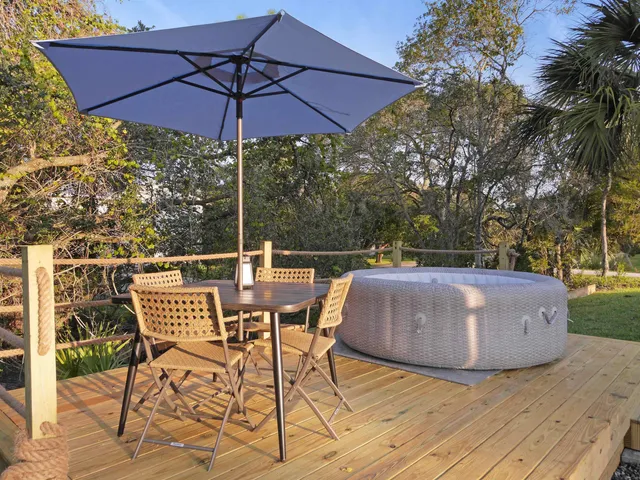 an aerial view of a house with a yard and mountain view in back