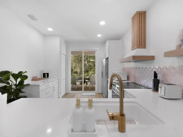 a kitchen with granite countertop a sink and a stove top oven