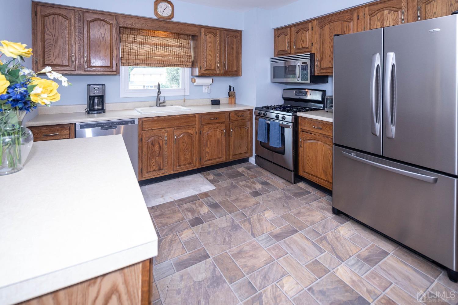 4 Overview Court Edison, NJ 08817 - Photo 13 of 44 a kitchen with stainless steel appliances a stove a refrigerator a sink a counter space and cabinets