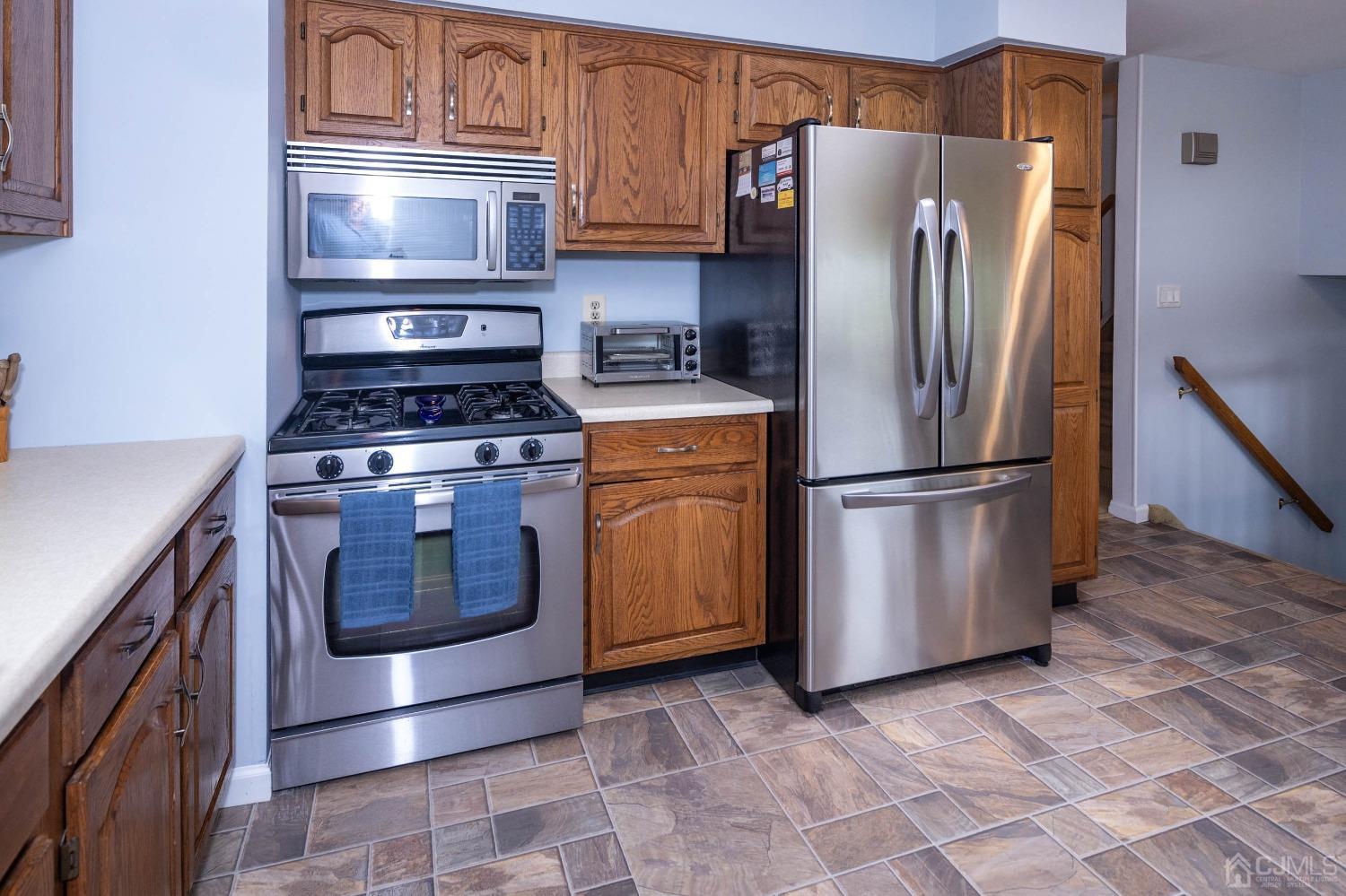 4 Overview Court Edison, NJ 08817 - Photo 14 of 44 a kitchen with appliances a sink and a refrigerator