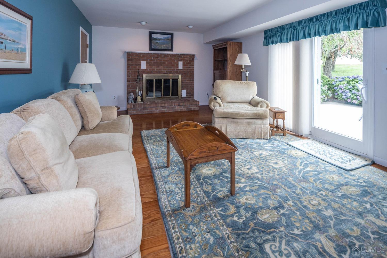4 Overview Court Edison, NJ 08817 - Photo 18 of 44 a living room with furniture a fireplace and a large window