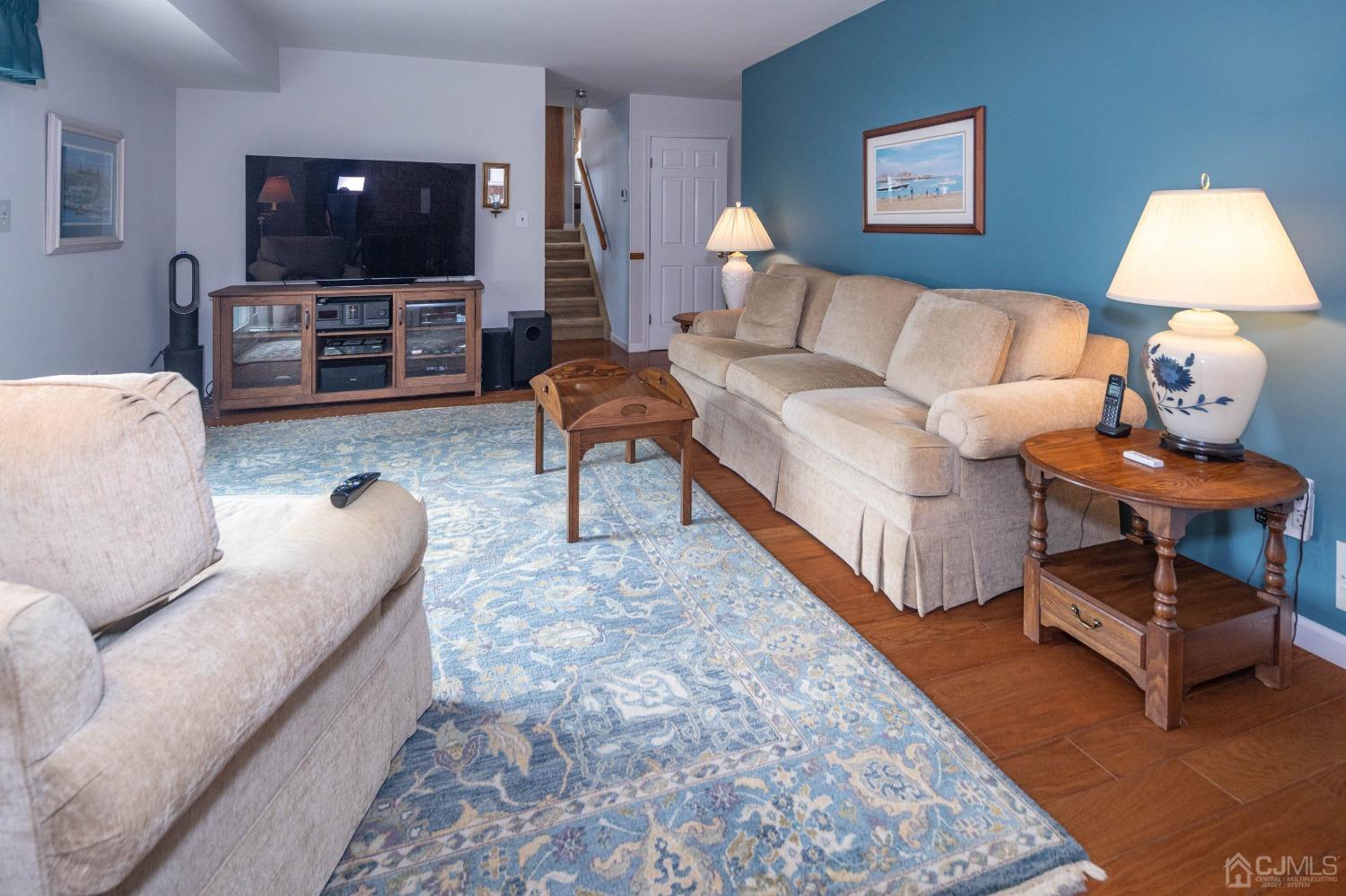 4 Overview Court Edison, NJ 08817 - Photo 20 of 44 a living room with furniture and a flat screen tv
