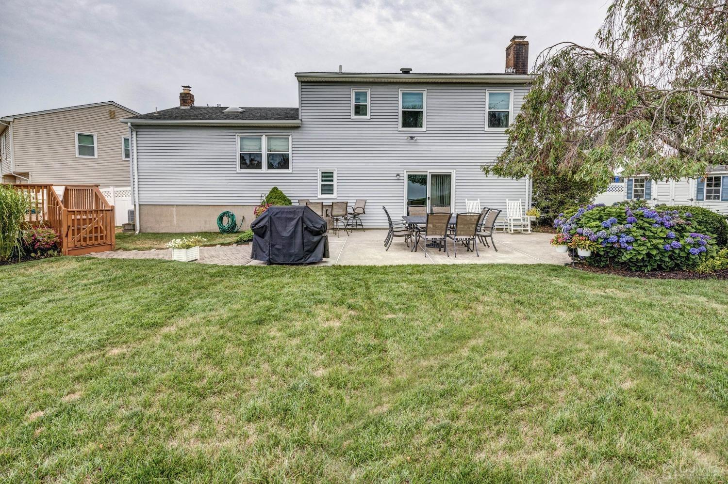 4 Overview Court Edison, NJ 08817 - Photo 39 of 44 a view of backyard of house with outdoor seating and green space