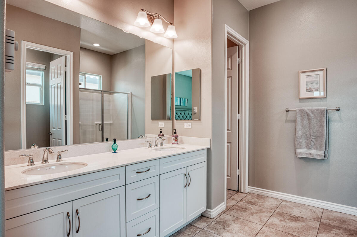 43775 Treviso Drive Indio, CA 92203 - Photo 13 of 47 a bathroom with a double vanity sink and a mirror
