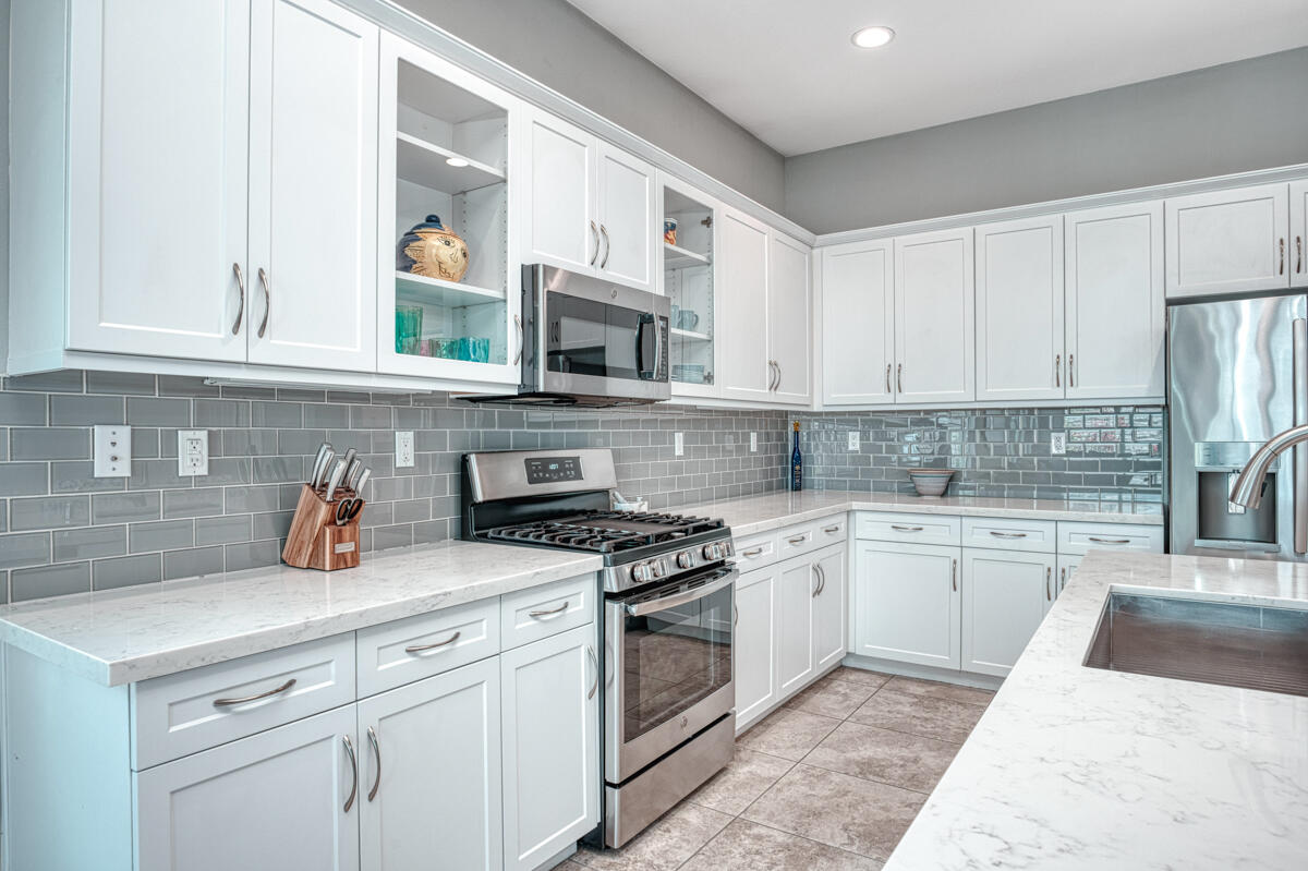43775 Treviso Drive Indio, CA 92203 - Photo 4 of 47 a kitchen with granite countertop white cabinets and stainless steel appliances