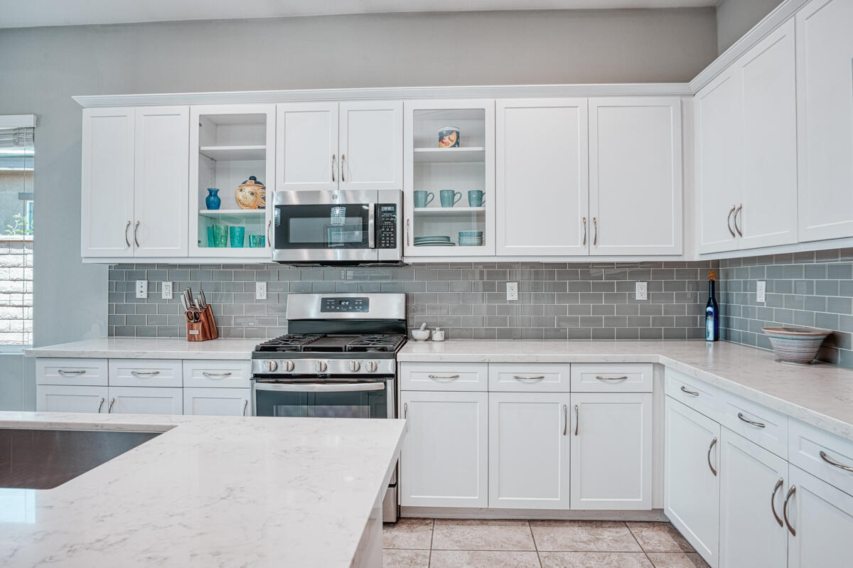 43775 Treviso Drive Indio, CA 92203 - Photo 5 of 47 a kitchen with white cabinets and appliances