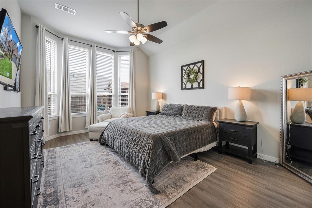 5664 Durst Lane Forney, TX 75126 - Photo 12 of 26 a spacious bedroom with a bed and a flat screen tv