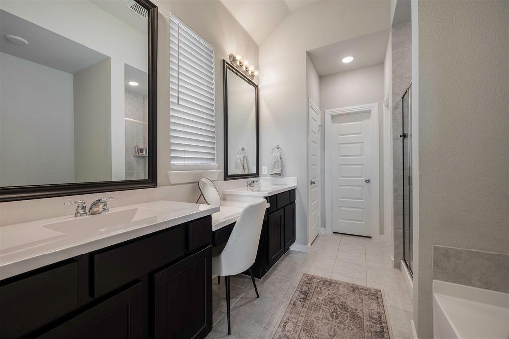 5664 Durst Lane Forney, TX 75126 - Photo 15 of 26 a spacious bathroom with a double vanity sink a mirror and a bathtub