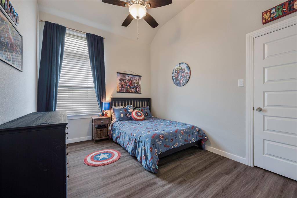 5664 Durst Lane Forney, TX 75126 - Photo 19 of 26 a bedroom with a bed and a table