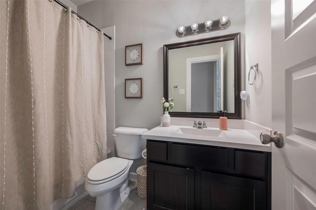 5664 Durst Lane Forney, TX 75126 - Photo 21 of 26 a bathroom with a sink toilet and mirror
