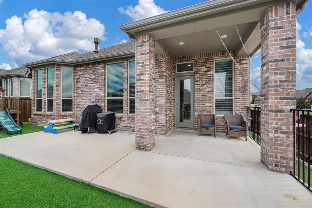 5664 Durst Lane Forney, TX 75126 - Photo 23 of 26 a view of a patio with table and chairs near a barbeque