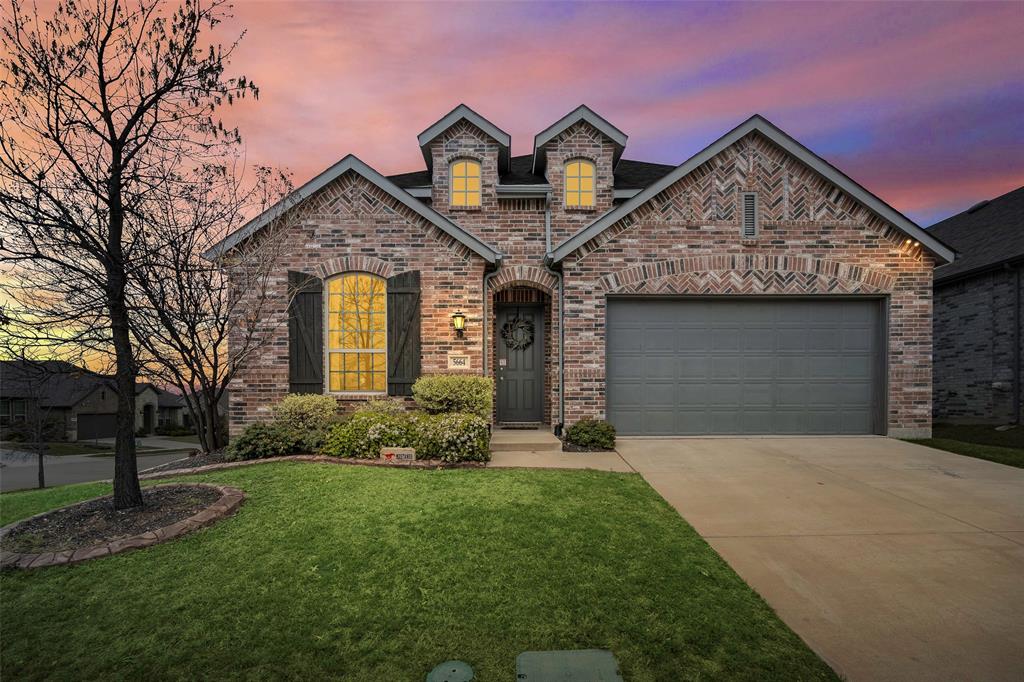 5664 Durst Lane Forney, TX 75126 - Photo 3 of 26 a front view of a house with a yard and garage