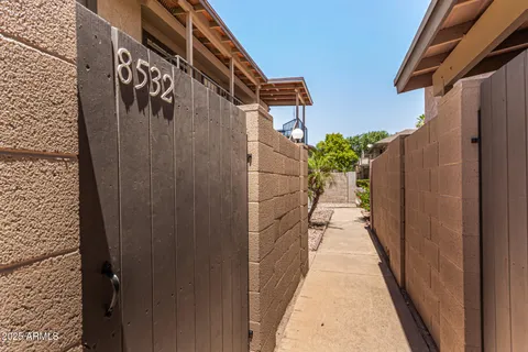 a pathway of a house with a yard