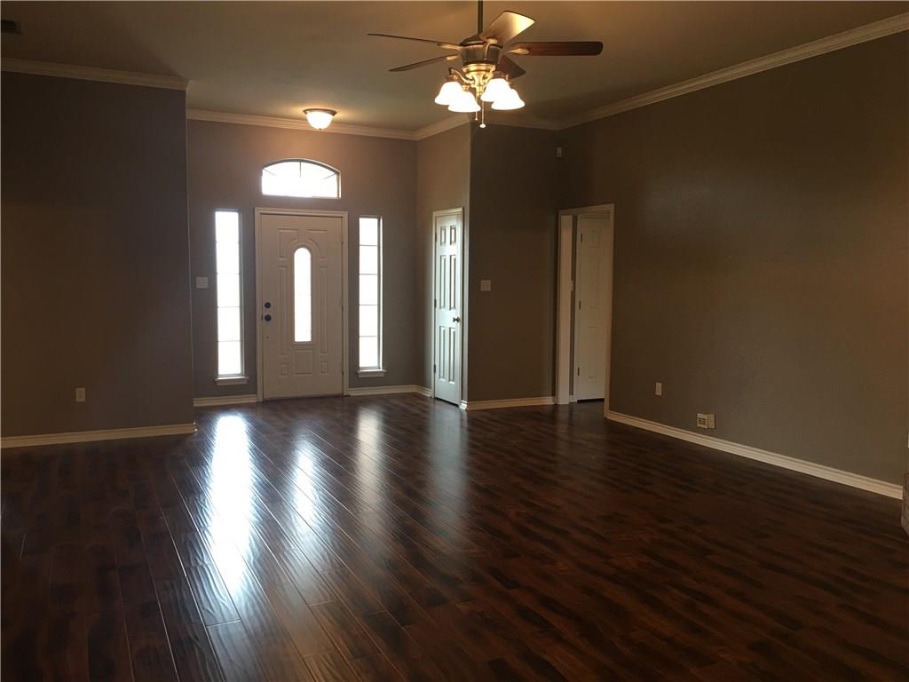 2218 Old Ironsides Road Abilene, TX 79601 - Photo 3 of 26 a view of a room with wooden floor and chandelier