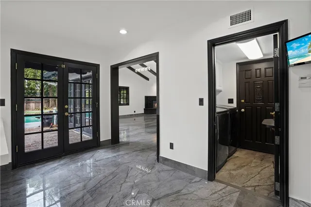a view of a hallway with wooden floor and a living room