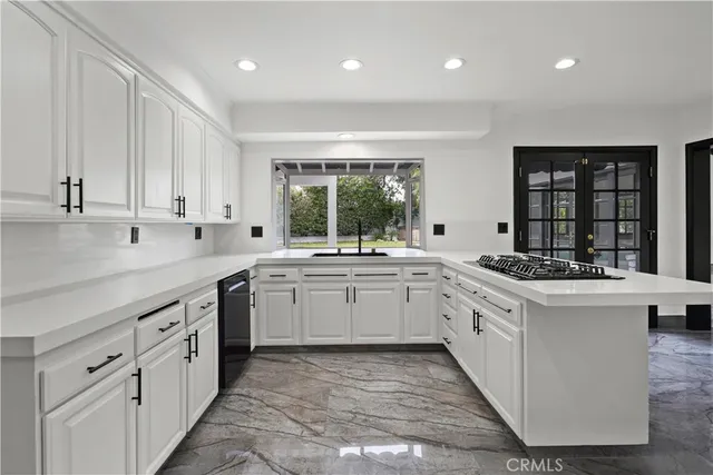 a kitchen with granite countertop white cabinets and white appliances