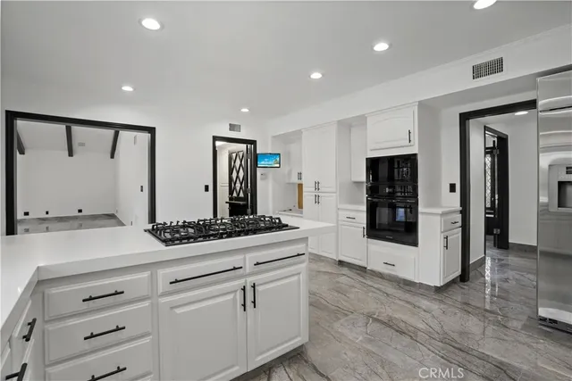 a spacious bathroom with a granite countertop sink and a mirror