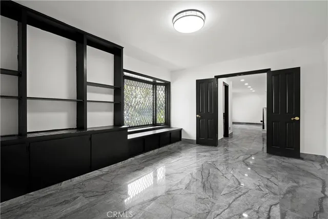 a view of a livingroom with wooden floor and a window