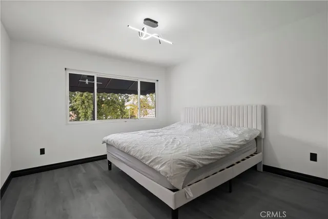 a bed sitting in a bedroom next to a window