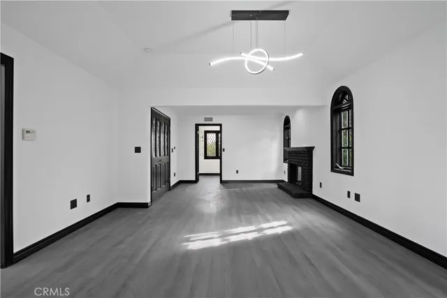 a view of a room with wooden floor and window