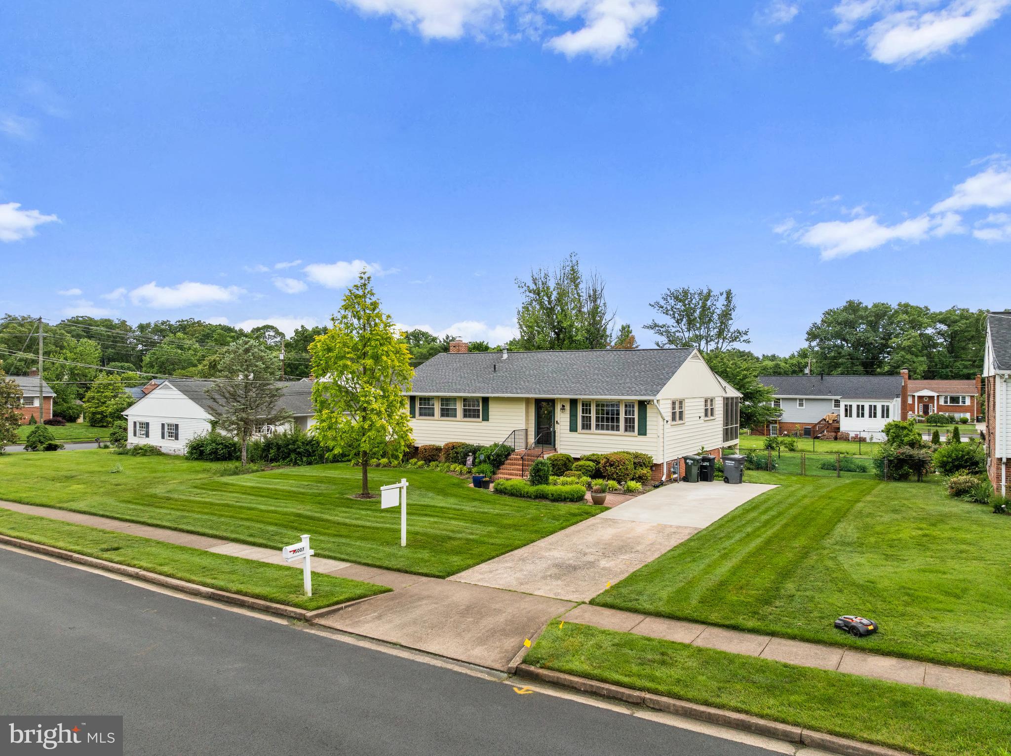 a front view of a house with a yard table and chairs