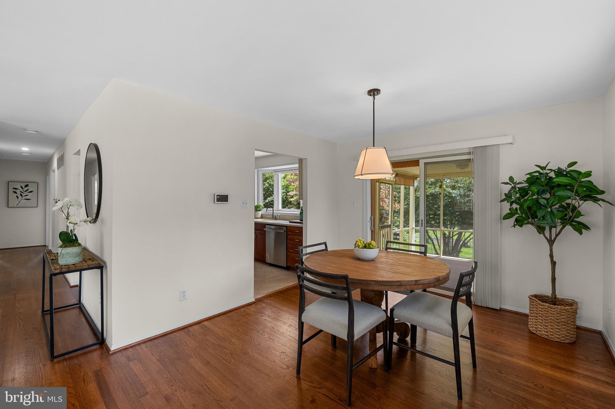 15007 Carlbern Drive Centreville, VA 20120 - Photo 17 of 47 a dining room with furniture potted plants and wooden floor
