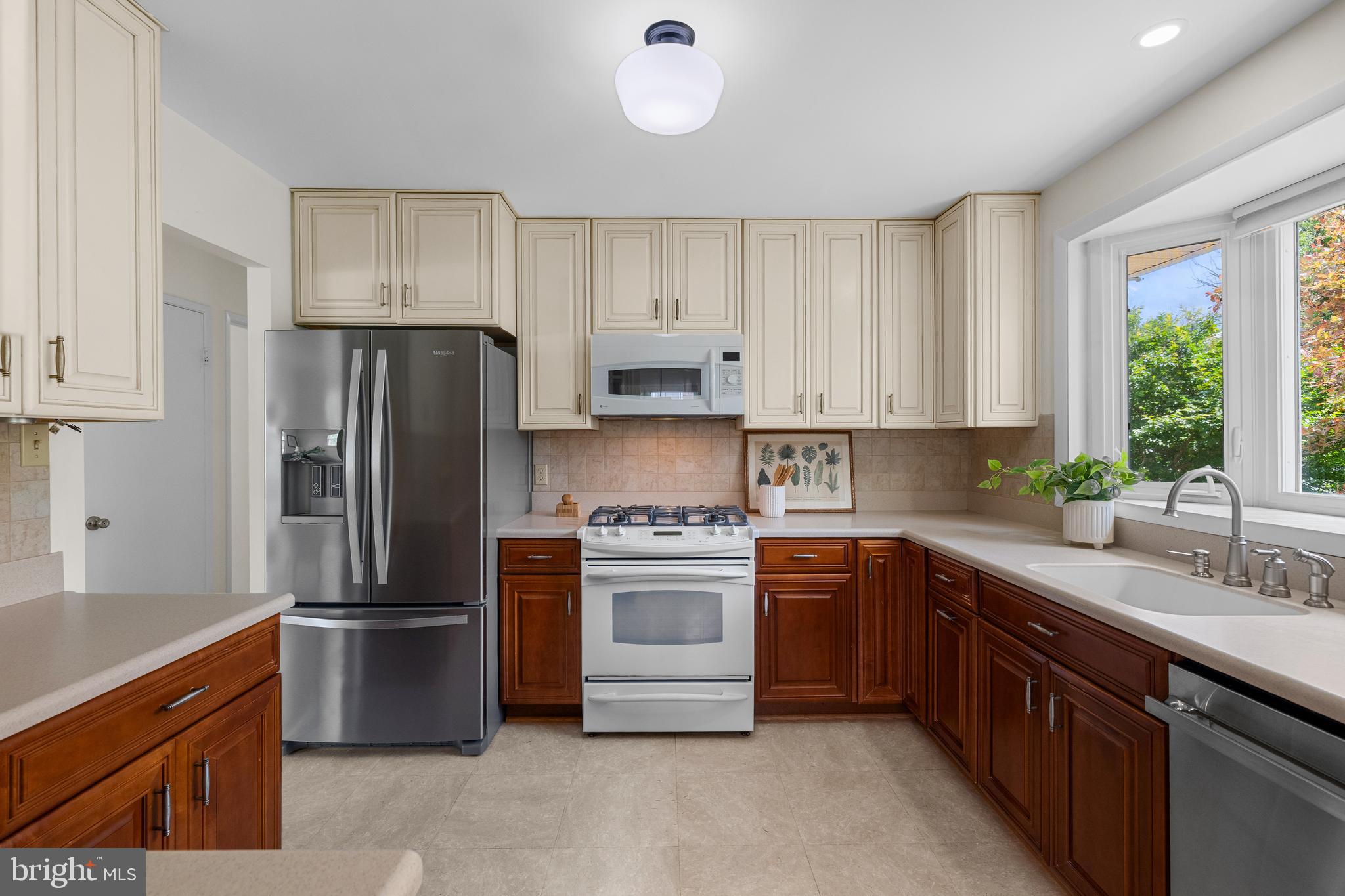 15007 Carlbern Drive Centreville, VA 20120 - Photo 19 of 47 a kitchen with stainless steel appliances white cabinets and a refrigerator