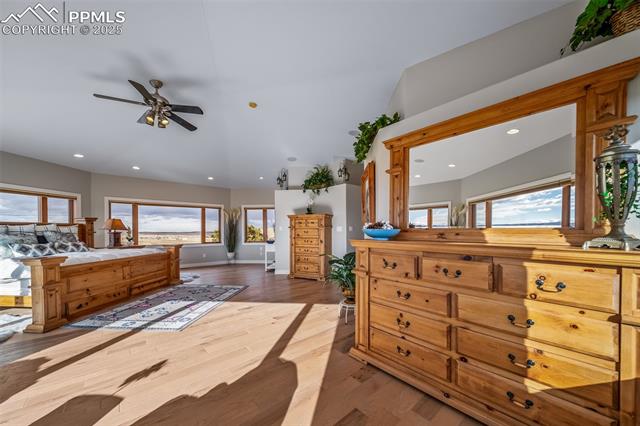 4586 East Best Road Larkspur, CO 80118 - Photo 23 of 50 Bedroom with multiple windows, wood finished floors, access to exterior, recessed lighting, and ceiling fan