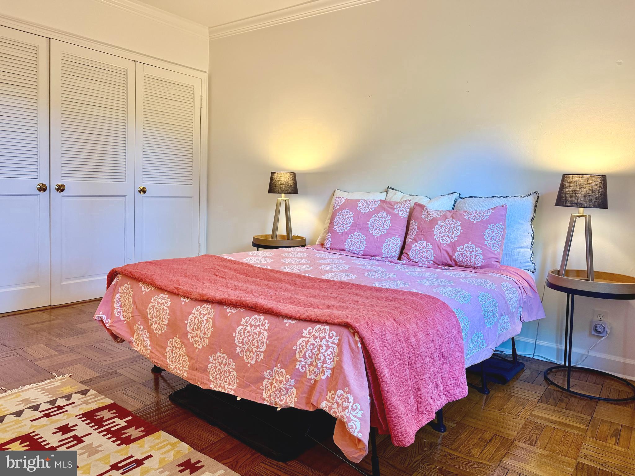 2500 Q Street Northwest, Unit 307 Washington, DC 20007 - Photo 10 of 17 a bedroom with a bed and a night stand