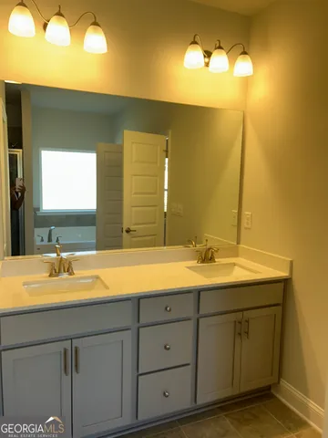 a bathroom with a double vanity sink and a mirror