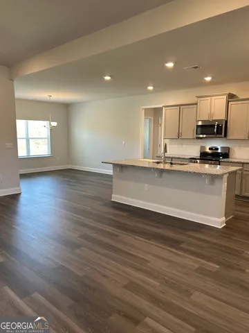 an empty room with wooden floor and window
