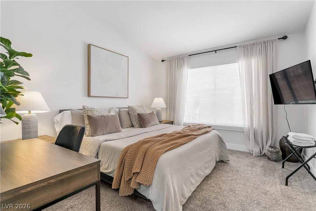 101 Beaver Ridge Avenue North Las Vegas, NV 89031 - Photo 15 of 42 Plush carpeting and a large window create a serene bedroom retreat.