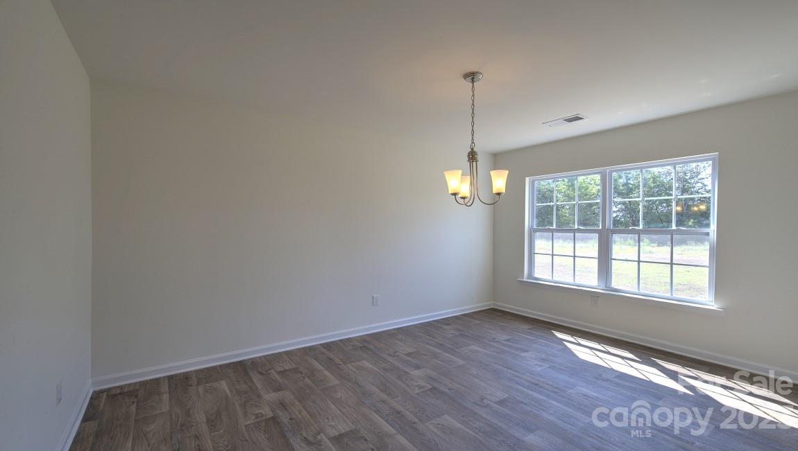 1374 Mifflin Lane Dallas, NC 28034 - Photo 15 of 20 a view of an empty room with wooden floor and a window