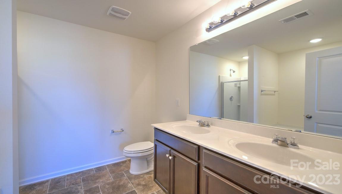 1374 Mifflin Lane Dallas, NC 28034 - Photo 17 of 20 a bathroom with a granite countertop sink a toilet and a mirror