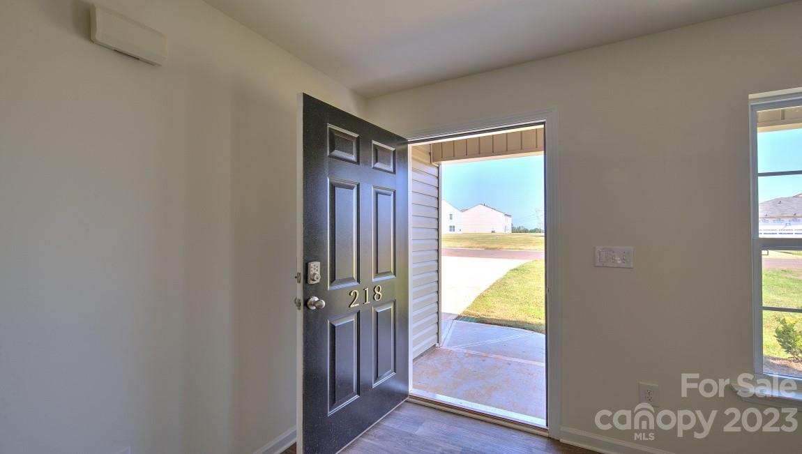1374 Mifflin Lane Dallas, NC 28034 - Photo 2 of 20 a view of a hallway with wooden floor and a dining room
