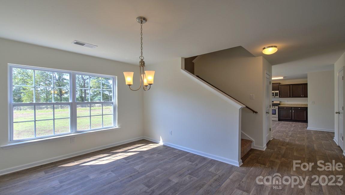 1374 Mifflin Lane Dallas, NC 28034 - Photo 5 of 20 a view of empty room with wooden floor and fan