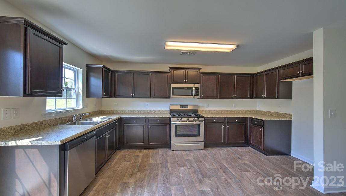 1374 Mifflin Lane Dallas, NC 28034 - Photo 7 of 20 a kitchen with stainless steel appliances granite countertop a stove a sink and a refrigerator