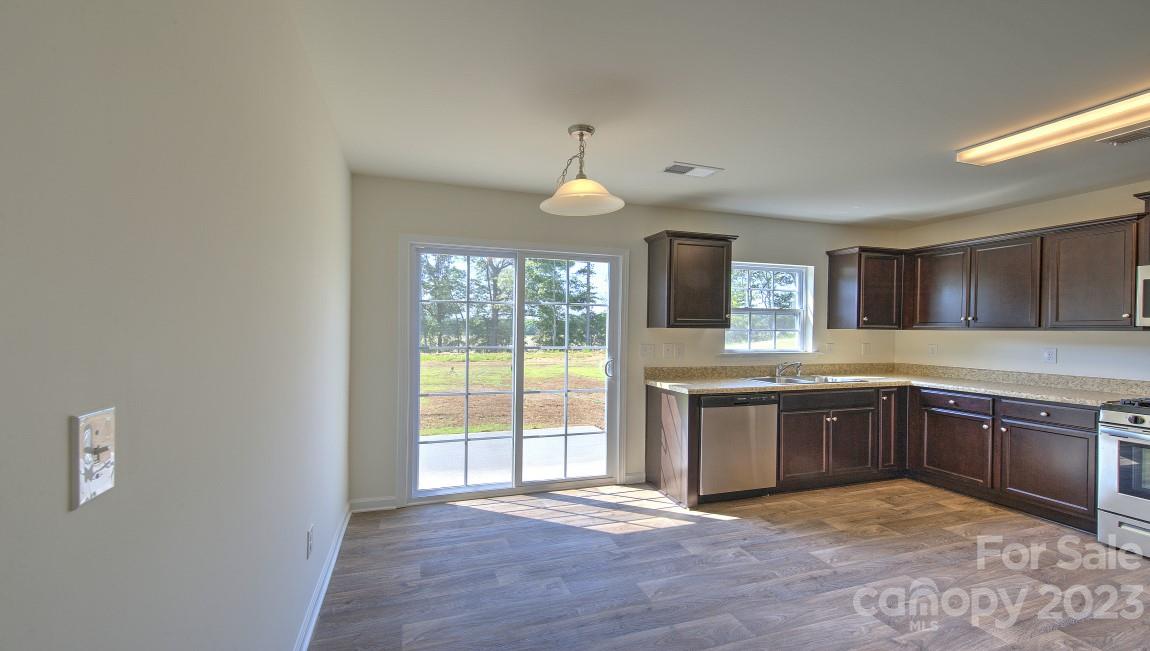 1374 Mifflin Lane Dallas, NC 28034 - Photo 8 of 20 a large kitchen with granite countertop a stove a sink and a granite counter top