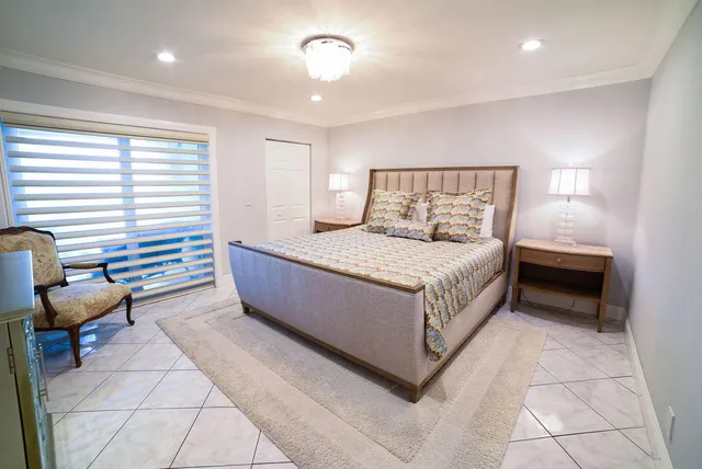 a bedroom with a bed and a chair