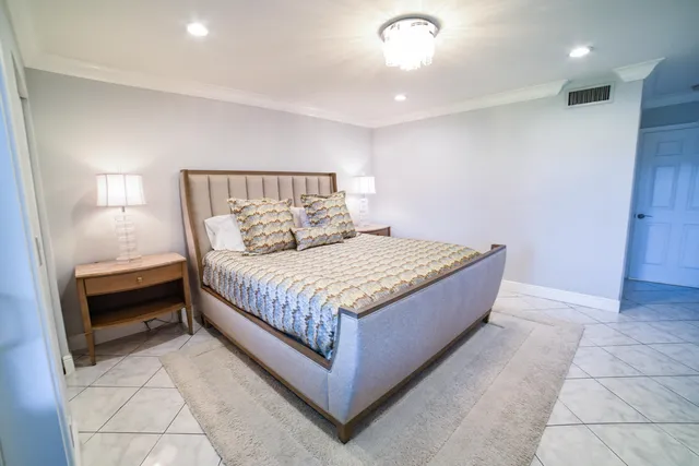 a large bedroom with a bed and a dresser