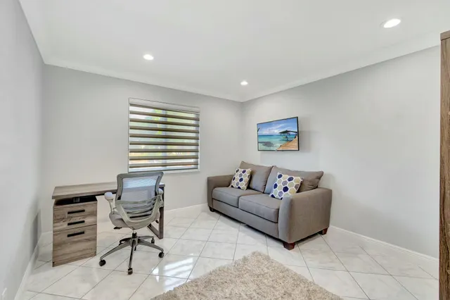 a living room with furniture a rug and a window