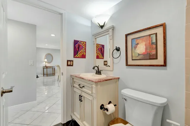 a bathroom with a sink mirror vanity and toilet