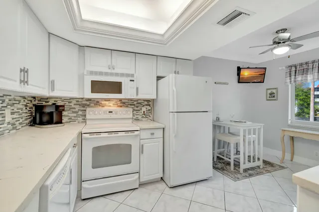 a kitchen with a stove a refrigerator and a sink